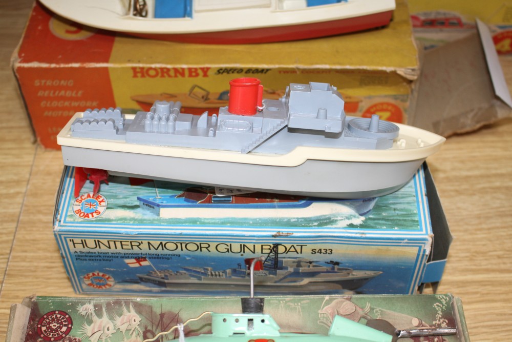 A boxed Sutcliffe model tinplate clockwork nautilus submarine, a boxed Scalex Hunter motor gun boat and two Hornby plastic bodied speed